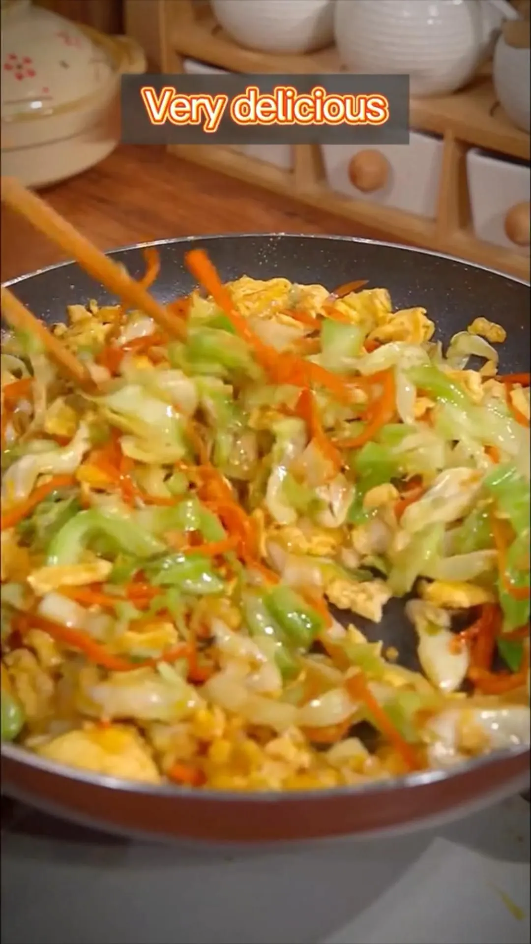 Vegetable stir-fry with cabbage, carrots, and scallions in a wok with savory sauce