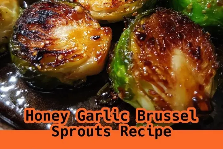 Caramelized honey garlic roasted Brussels sprouts in a bowl with sesame seeds and garlic pieces
